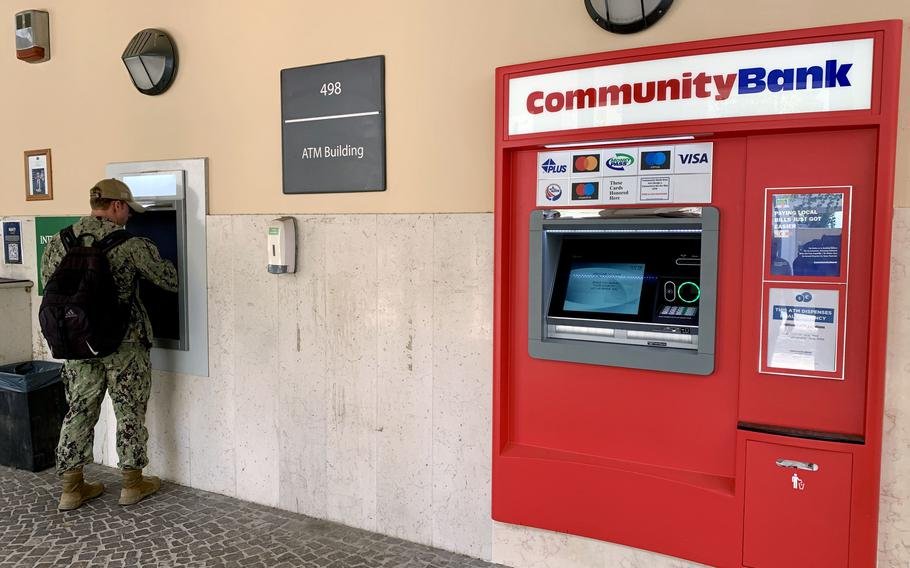 A sailor uses an ATM at U.S. Naval Support Activity Naples in Italy on July 24, 2024. Starting Monday, service members and other customers of Community Bank no longer will have a U.S. currency option in the online bill payment system.