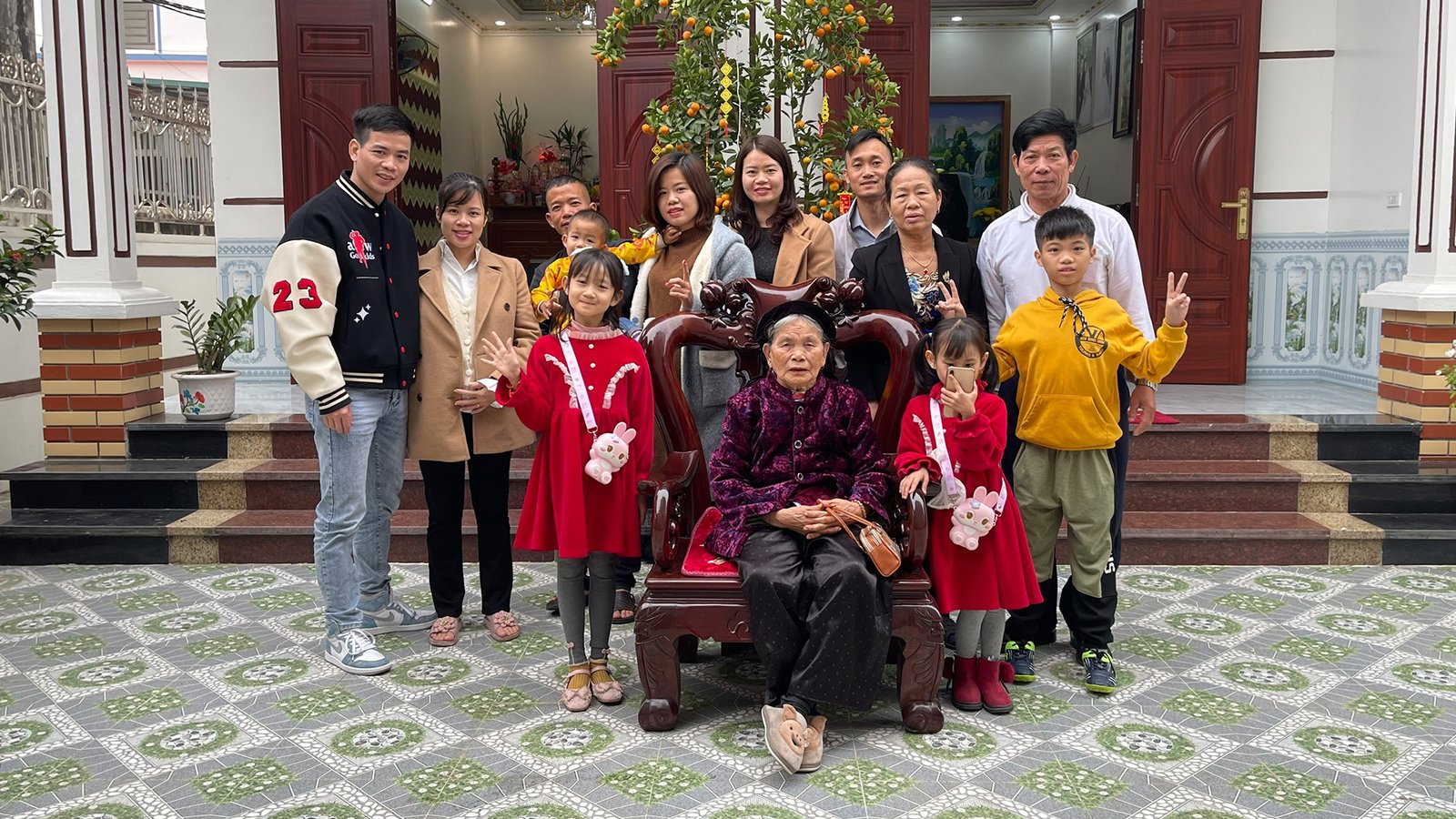 Mr. Nguyen Duc Thành, on the far left, with his extended family in Vietnam.