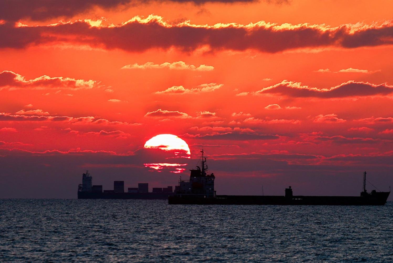 Freighters ply the Mediterranean Sea off Israel at sunset on Thursday, amidst the ongoing conflict in Gaza. REUTERS