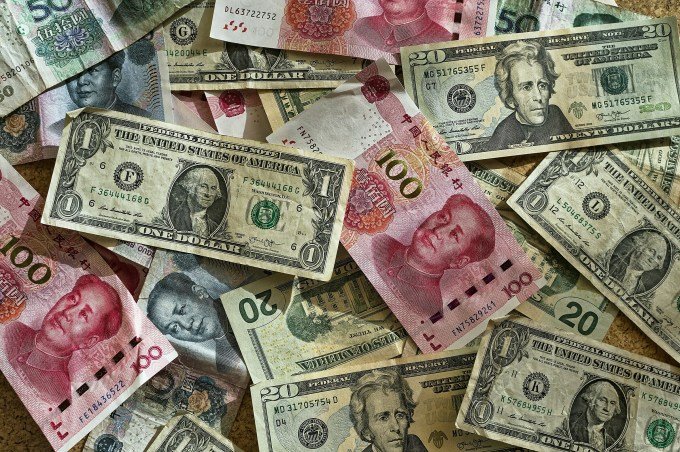 Chinese yuan and U.S. dollars. Illustration by Unsplash